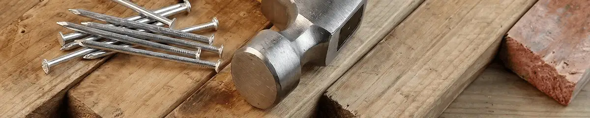 Hammer and nails on hardwood flooring boards in Anchorage, AK