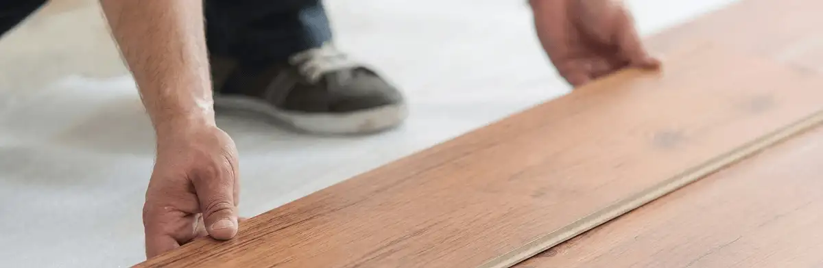 A professional installing laminate flooring in Anchorage, AK