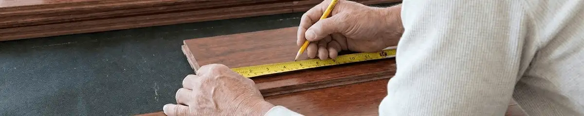 A professional installing wood flooring in Anchorage, AK